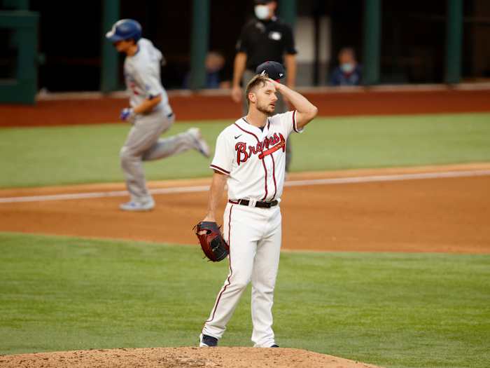Oct 14, 2020; Arlington, Texas, USA; Atlanta Braves relief pitcher Grant Dayton (75) reacts after giving up a home run to Los Angeles Dodgers shortstop Corey Seager (background) during the third inning of game three of the 2020 NLCS at Globe Life Field.
